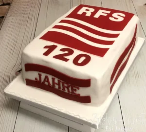 Rechteckige weiße Jubiläumstorte für die Firma RFS, mit rotem Logo, Aufschrift "120 Jahre" und dem Hinweis "Himbeer-Mascarpone" im Dateinamen.