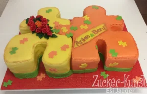 Zweiteilige Hochzeitstorte mit einem gelben und einem orangenen Puzzlemotiv